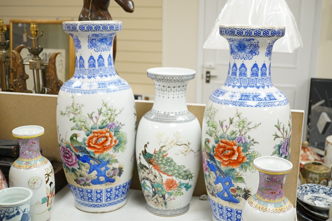 A large pair of Chinese polychrome vases, 60cm high, a pair of famille rose vases, a blue and white brushpot and two other vases (7).